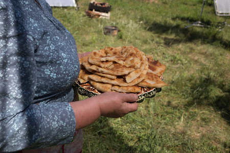 Woman is holding appetite national pies in hands.