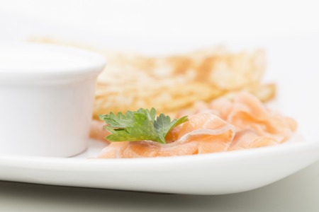 Fragment of breakfast with salmon and blinis. Close-up.の写真素材