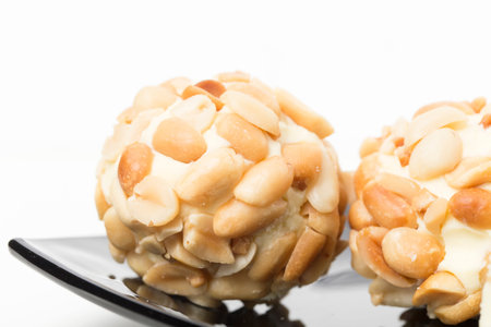Close-up image of nougat was coated peanuts. There is a place for text on a white background.