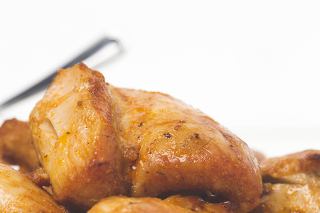 Pieces of fried meat close up on a white background. There is a place for text on a white background.の写真素材