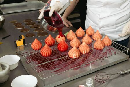 The process of applying fruit glaze cakes. Close-up.の写真素材