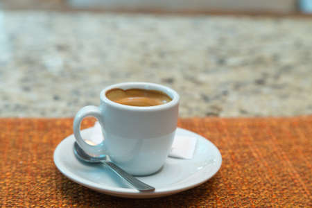 Cup of coffee on a wooden table. Close-up.の写真素材