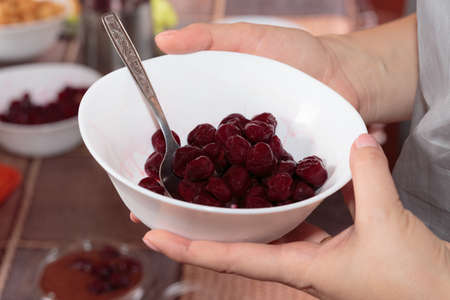 Thawed cherries on the white bowl. Close-up.の写真素材
