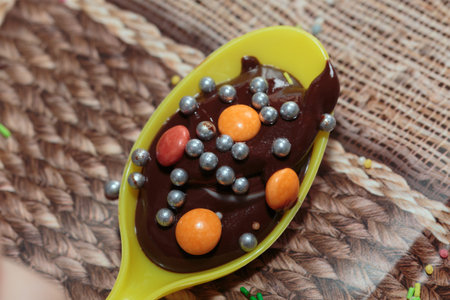 Decorating chocolate with various sprinkles. Close-up.
