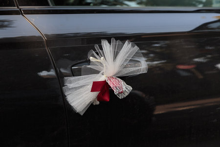 Wedding car. Wedding decoration on wedding car. Luxury wedding car decorated with bow. Close-up.の写真素材