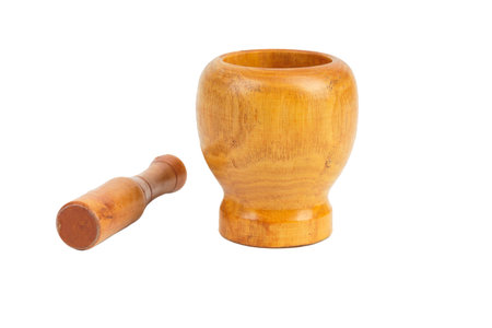 Handmade wooden mortar for grinding spices. Isolated over white background. Close-up.の写真素材