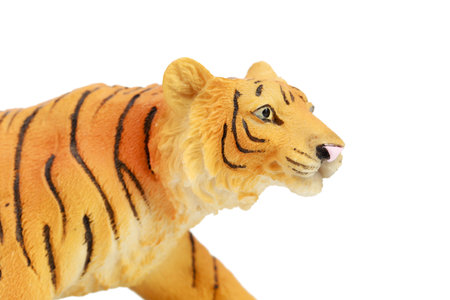 A tiger figurine made of plastic. Isolated over white background. Close-up.の写真素材
