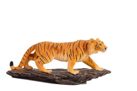 A tiger figurine made of plastic. Isolated over white background. Close-up.の写真素材