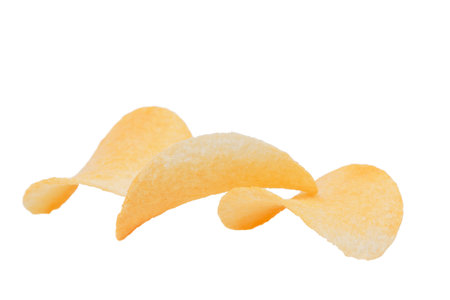 Three goldish deliciouse potato chips. Isolated over white background. Close-up.の写真素材