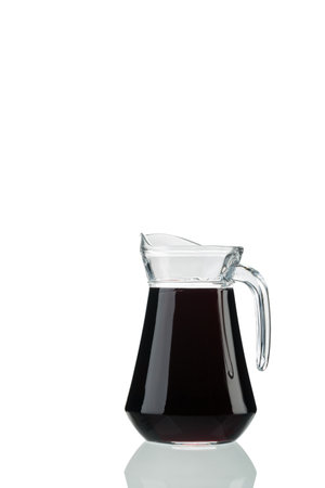 A jug of red wine with vertical highlights. Isolated over white background. Close-up.の写真素材