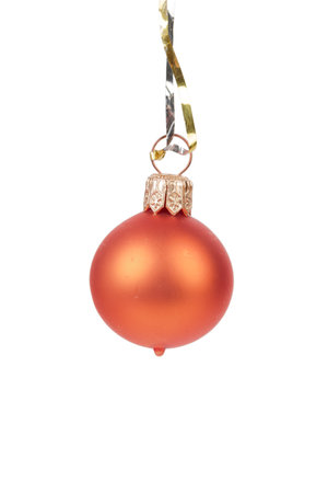 Orange Christmas ball on a gold ribbon. Isolated over white background. Close-up.の写真素材