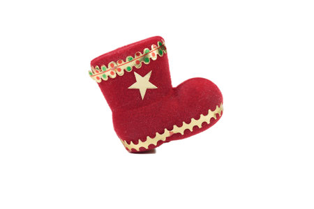 Christmas decoration red felt boot. Isolated over white background. Close-up.の写真素材