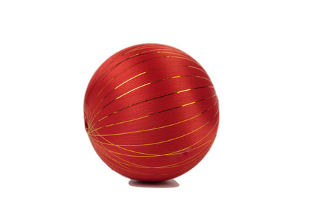 Red Christmas ball without ribbon. Isolated over white background. Close-up.の写真素材