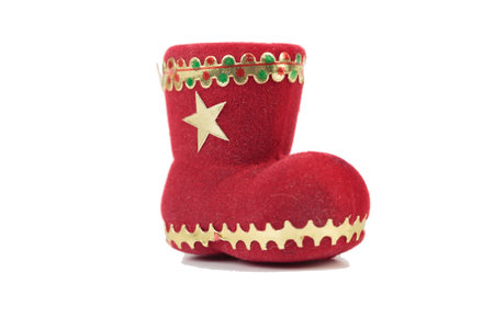 Christmas decoration red felt boot. Isolated over white background. Close-up.の写真素材