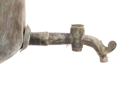 Faucet of old dirty Russian samovar in a cobweb. It is located on a white background. Close-up.の写真素材