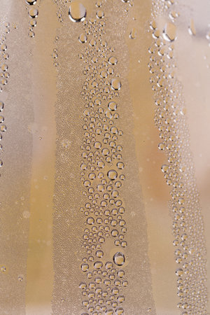 Drops and trickles of water on the glass. It occupies the entire surface of the image. Close-up.の写真素材