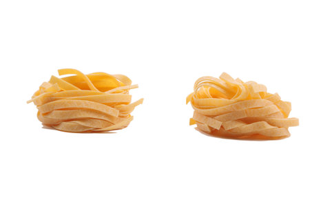 Italian fettuccine pasta in the form of a nest. Isolated over white background. Close-up.の写真素材
