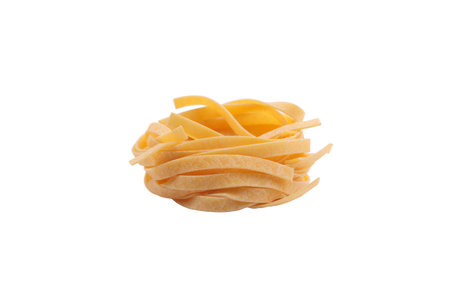 Italian fettuccine pasta in the form of a nest. Isolated over white background. Close-up.の写真素材