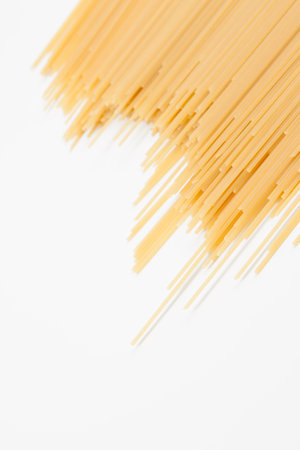 Spaghetti spread out on a white surface. There is a place for the text. Close-up.の写真素材