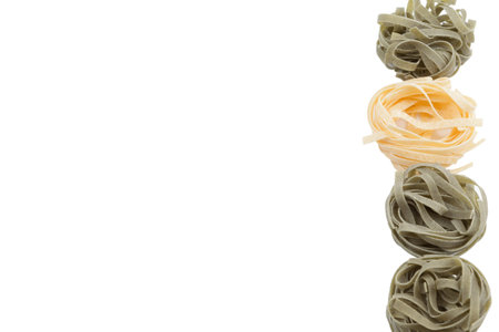 Italian fettuccine pasta in the form of a nest. Isolated over white background. Close-up.の写真素材