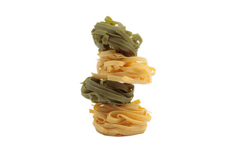 Italian fettuccine pasta in the form of a nest. Isolated over white background. Close-up.の写真素材