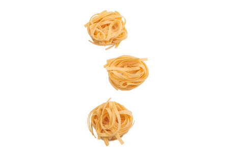Italian fettuccine pasta in the form of a nest. Isolated over white background. Close-up.の写真素材