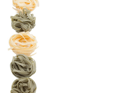 Italian fettuccine pasta in the form of a nest. Isolated over white background. Close-up.の写真素材