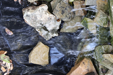 Streams of water over stones. Close-up.の写真素材
