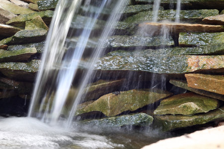 Streams of water over stones. Close-up.の写真素材