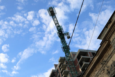 Symbiosis of old and new buildings. Urban landscape with blue sky.の写真素材
