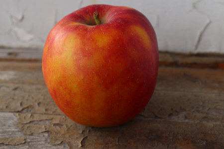 Ripe apple. It is located on an old wooden windowsill. Close-up.の写真素材