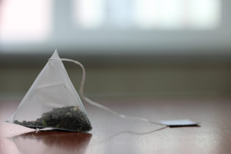 Green tea bag on a table. Close-up. There is a place for the text.の写真素材