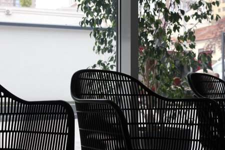 Black chair in studio for working space. Comfortable office chair or cafe chair. Modern furniture for house decor, real estate, property, living.の写真素材