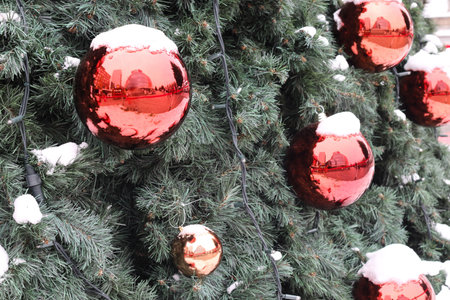 Fir branch with balls and festive lights. A festive decoration on Christmas Eve.の写真素材