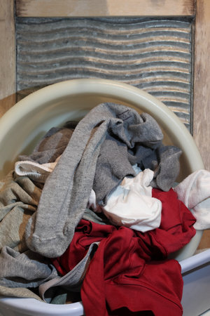 A basin with dirty laundry on the washing board. It occupies the entire surface of the image. Copy space. Close-up.の写真素材