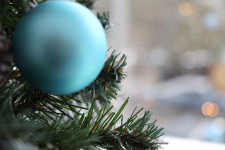 Fir branch with balls and festive lights. A festive decoration on Christmas Eve.の写真素材