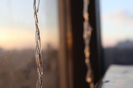 LED garland on a blurred background. View from the window of the evening city.の写真素材
