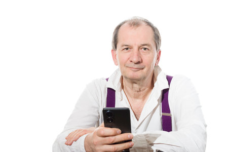 Portrait of a sixty-year-old man in a white shirt. Isolated over white background. Close-up.の写真素材