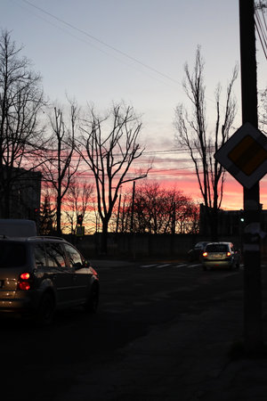 Dark silhouettes against a bright sunset sky. It's a beautiful cityscape.の写真素材