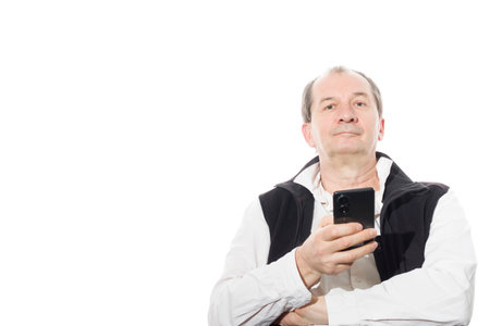 Portrait of a sixty-year-old man in a black vest. Isolated over white background. Close-up.の写真素材