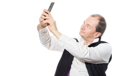 Portrait of a sixty-year-old man in a black vest. Isolated over white background. Close-up.の写真素材