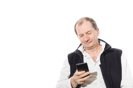 Portrait of a sixty-year-old man in a black vest. Isolated over white background. Close-up.の写真素材