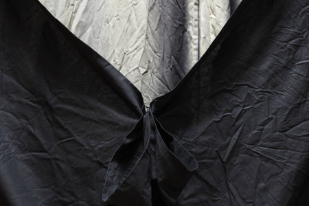 Abstract background made of black and gray calico. It occupies the entire surface of the image. It's like a curtain for a stage. Close-up.の写真素材