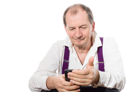 Portrait of a sixty-year-old man in a white shirt. Isolated over white background. Close-up.の写真素材