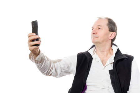 Portrait of a sixty-year-old man in a black vest. Isolated over white background. Close-up.の写真素材