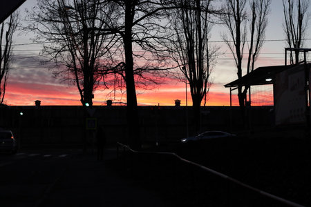 Dark silhouettes against a bright sunset sky. It's a beautiful cityscape.の写真素材