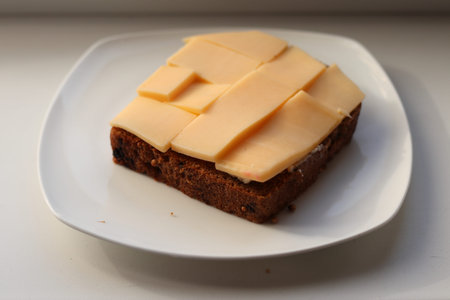 Bread with butter and cheese. Breakfast. Highlighted on a white background. Close-up.