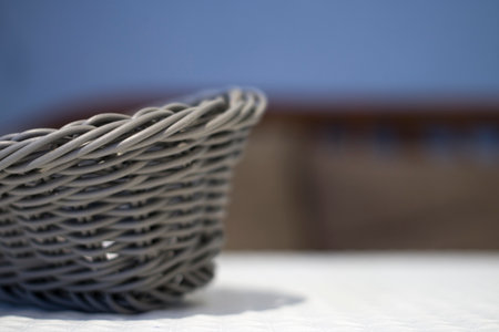 Artificial wicker basket on the table in the cafe. Close-up.の写真素材