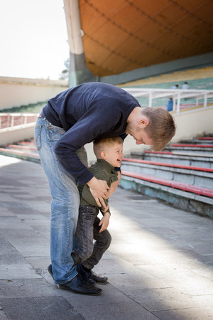 Father and son playing in empty stadium  の写真素材