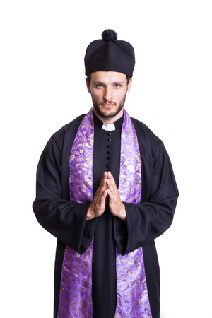 Humble Christian priest. Studio portrait isolated on white background  の写真素材